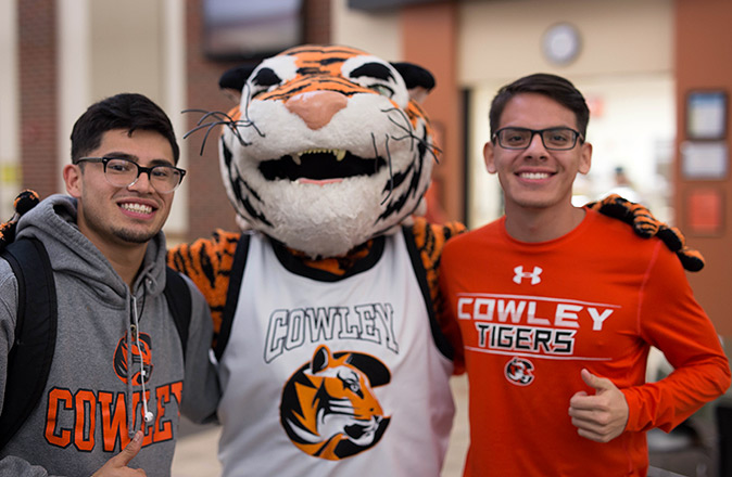 Two Cowley College students with Tank the Mascot.